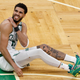 Boston’s Jayson Tatum lies on the court after a possible injury in the fourth quarter against the Miami Heat in Game Three of the 2022 NBA Playoffs Eastern Conference Finals.